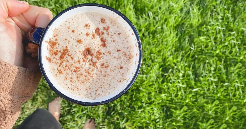 Coffee with Pumpkin Spice Coffee Creamer with grass in the background